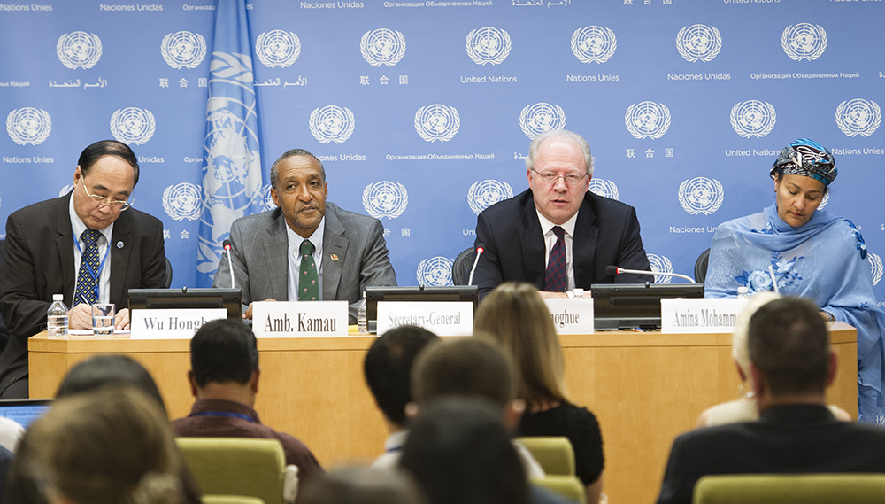 The Permanent Representatives of Kenya and Ireland (center left and center right) announce the adoption of the document at a press conference in UN headquarters on Sunday. Photo: UN Photo